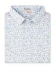 Route 66 Polo in Herb featuring an all-over illustrated print inspired by classic roadside landmarks, cars, palm trees, and desert scenery.