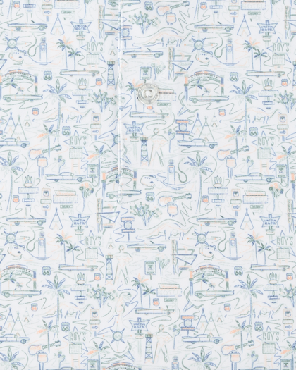 Close-up of the Route 66 Polo fabric highlighting the detailed roadside-inspired print with cars, signs, palm trees, guitars, and desert motifs.