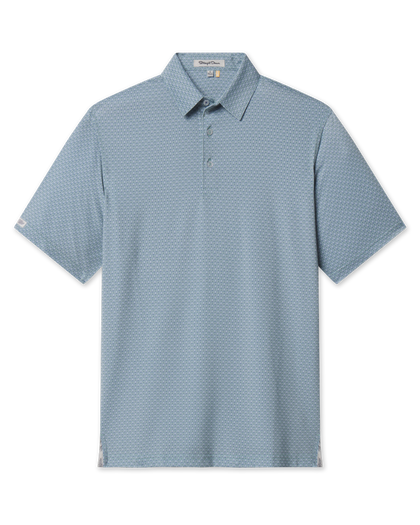 A soft green-blue short-sleeve polo shirt with a subtle repeating cattle skull pattern, featuring a classic collar and a three-button placket.