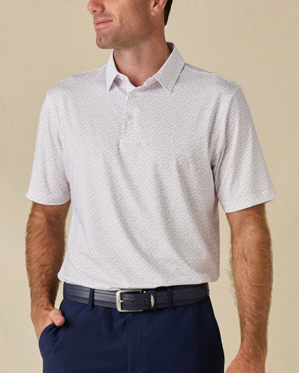 Model wearing the Pink Flamingo Polo in Sea Shell, featuring a small-scale pink and blue flamingo print.
