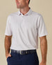 Model wearing the Pink Flamingo Polo in Sea Shell, featuring a small-scale pink and blue flamingo print.