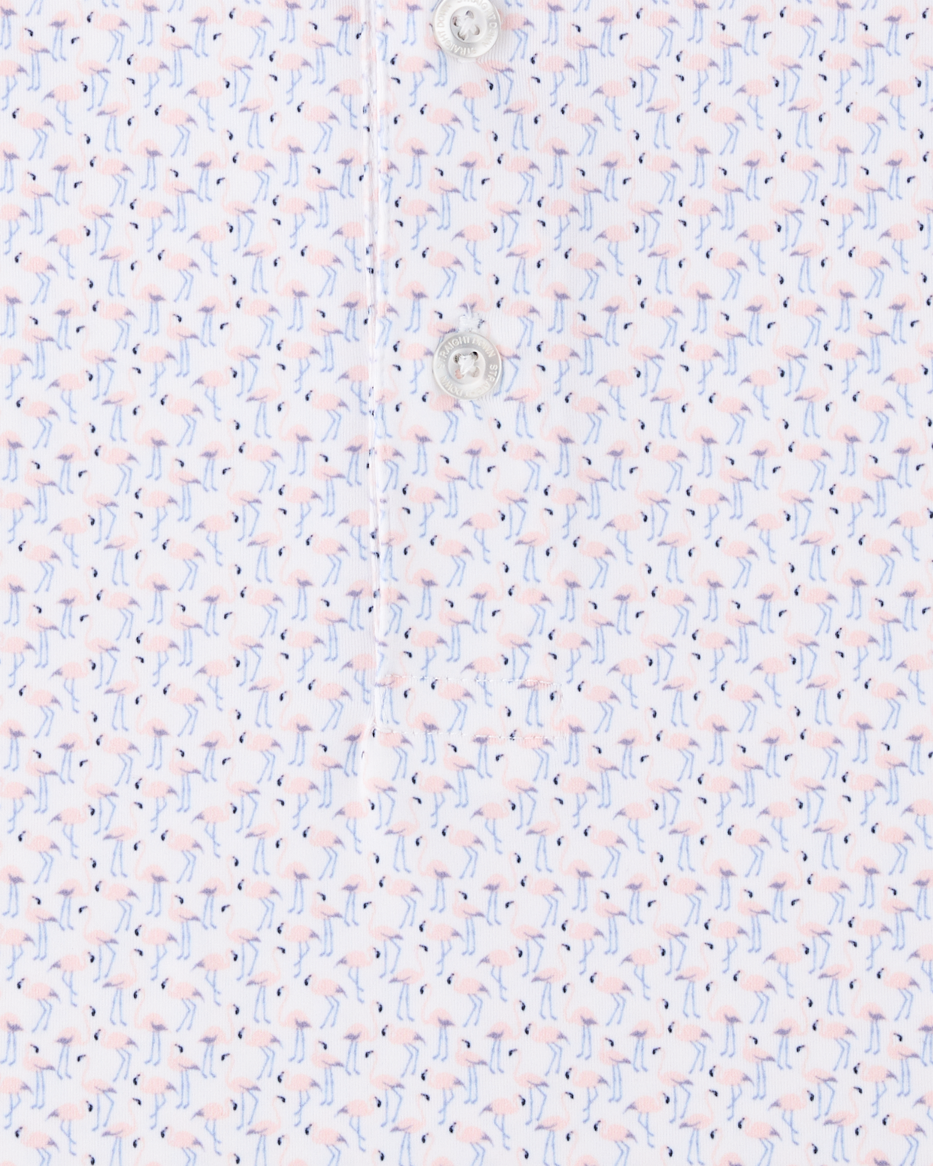 Close-up of the Pink Flamingo Polo in Seashell, highlighting the detailed pink flamingo print with light blue legs, navy accents, and branded button detail.