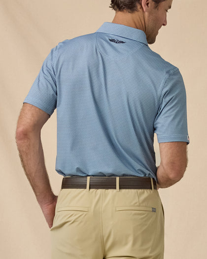 F-16 Polo in Nantucket Blue, angled back view paired with khaki shorts