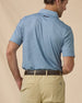 F-16 Polo in Nantucket Blue, angled back view paired with khaki shorts