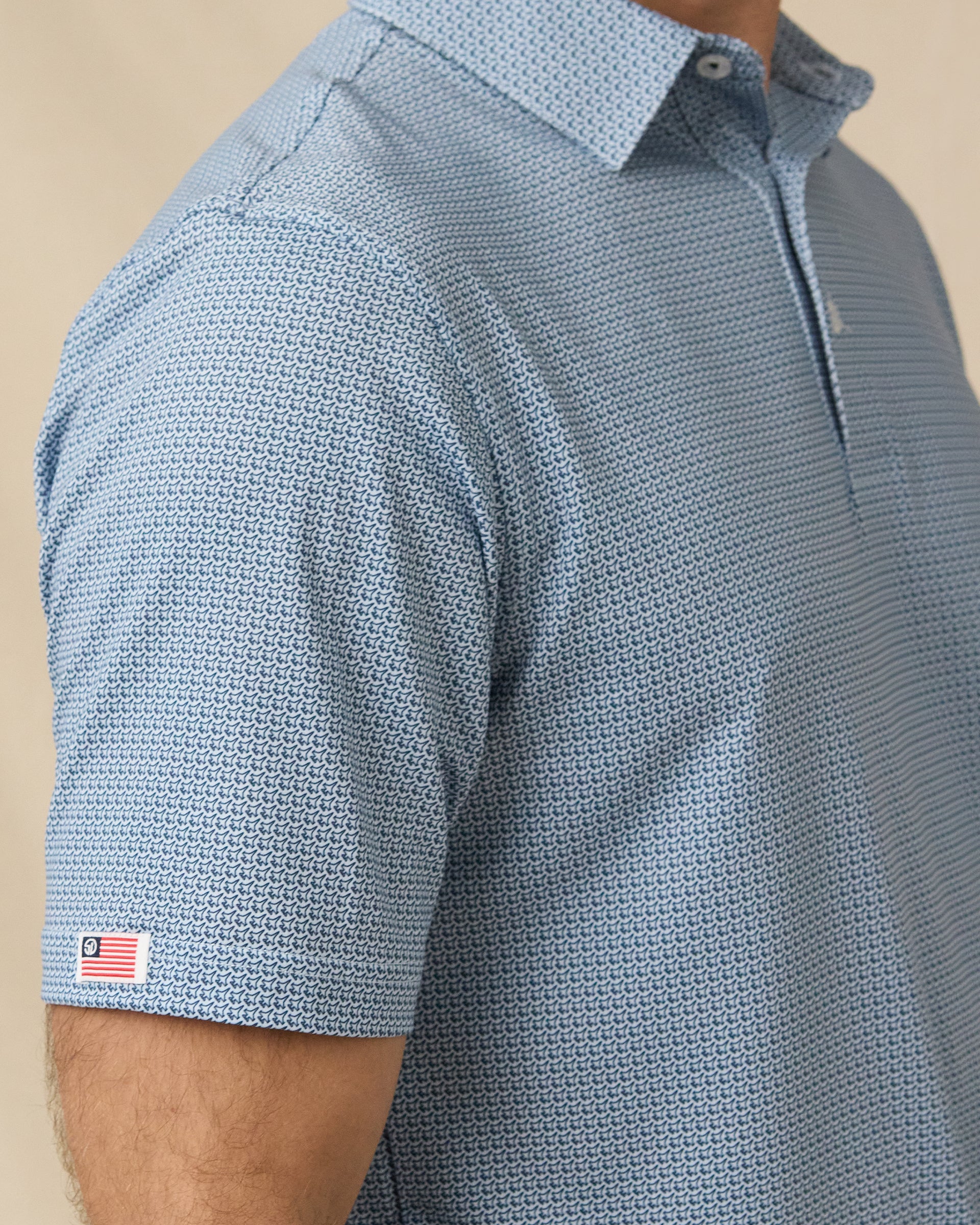 F-16 Polo in Nantucket Blue with sleeve flag logo detail close-up