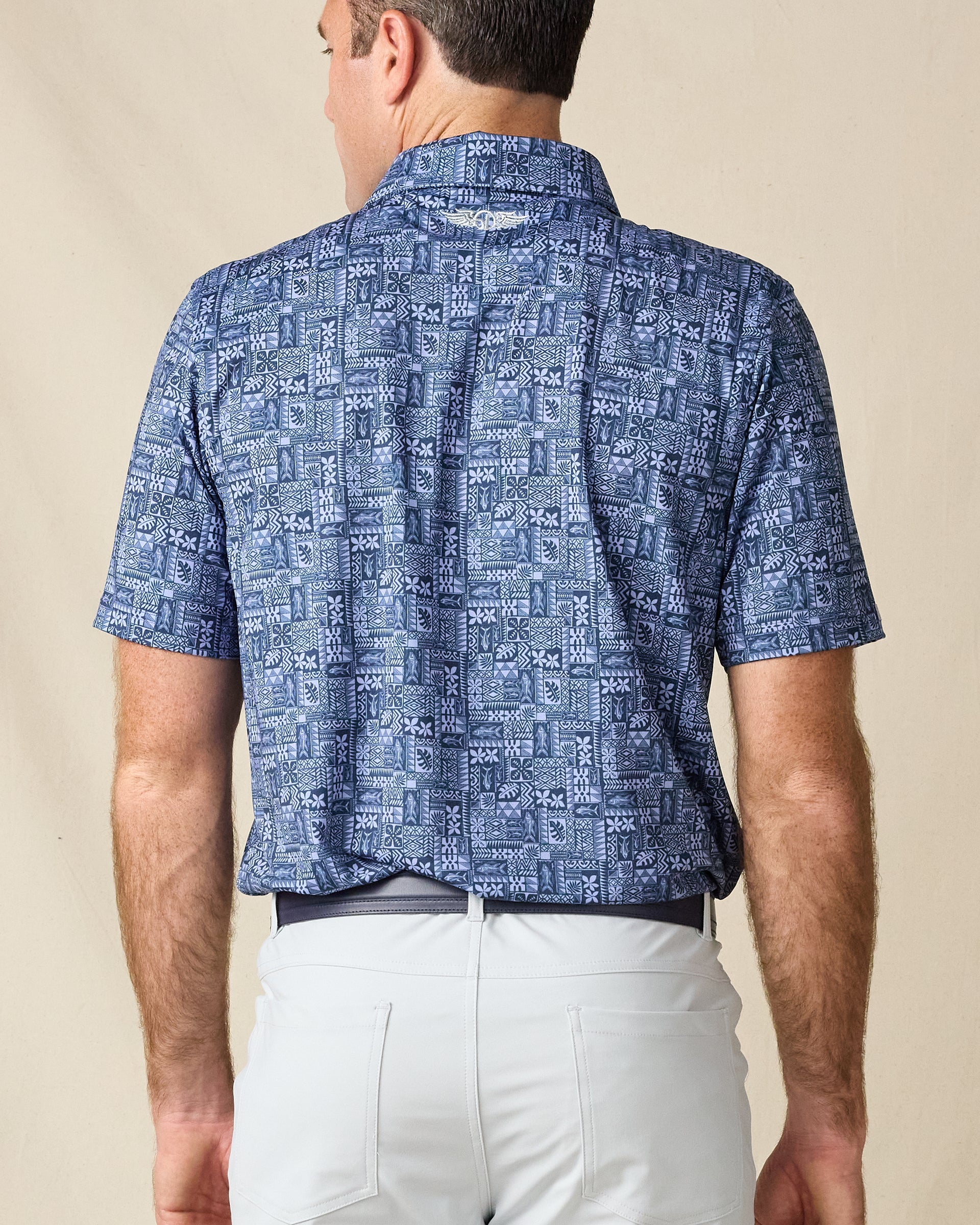 Back view of the Reef Runner Polo in Blue Shade, highlighting the detailed allover print and embroidered Straight Down logo below the collar.