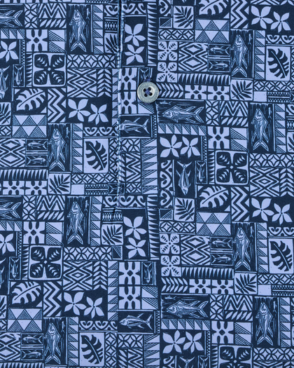 Close-up of the Reef Runner Polo in Blue Shade, highlighting the detailed fish, floral, leaf, and geometric motifs with branded button detail.