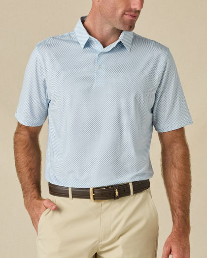 Model wearing the Check Mate Polo in Mint Tea, featuring a small all-over cross pattern and classic polo collar.