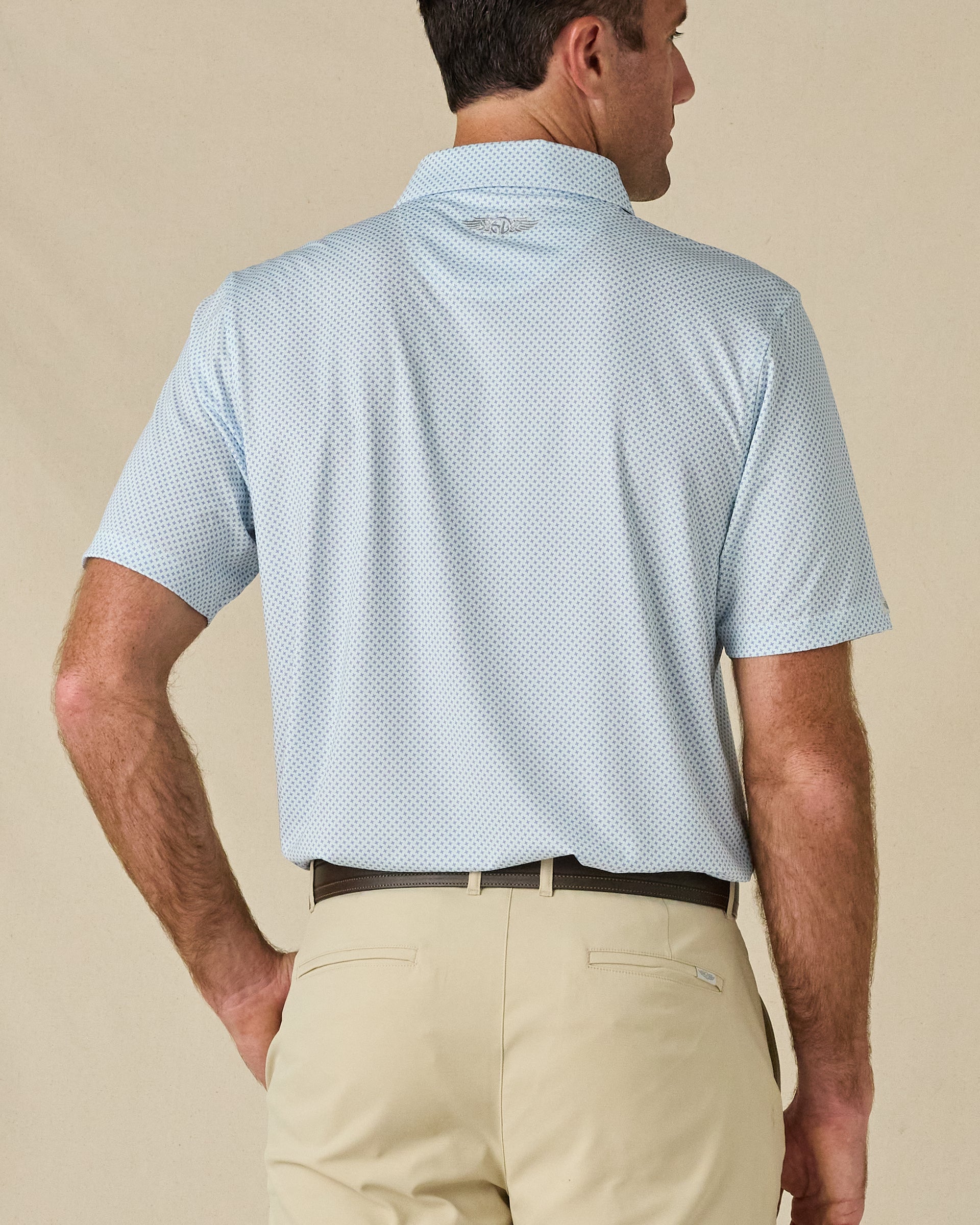Back view of the Check Mate Polo in Mint Tea, highlighting the all-over print and embroidered logo below the collar.
