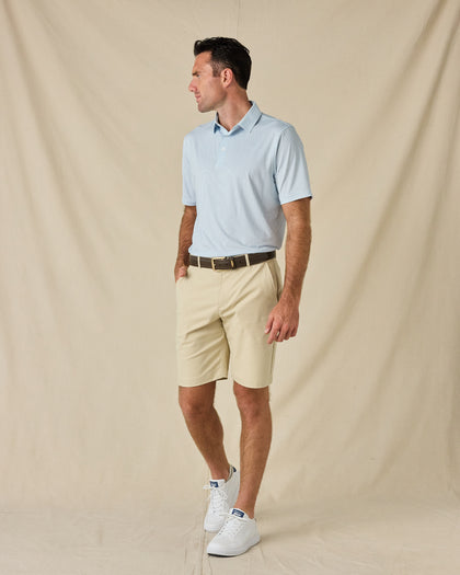 Model wearing the Check Mate Polo in Mint Tea with khaki golf shorts, a brown belt, and white sneakers.