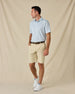Model wearing the Check Mate Polo in Mint Tea with khaki golf shorts, a brown belt, and white sneakers.