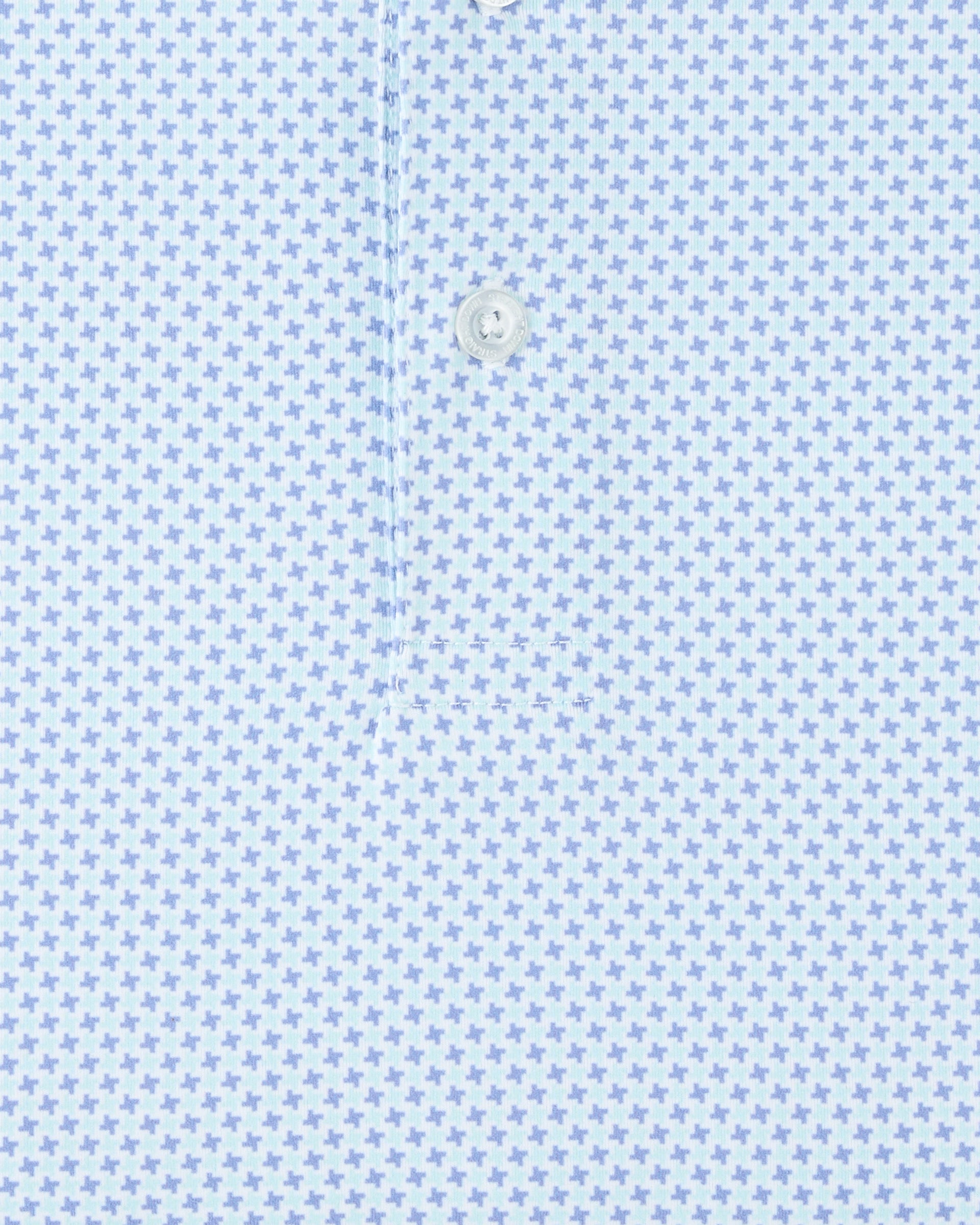 Close-up of the Check Mate Polo in Mint Tea, highlighting the repeating blue geometric pattern and branded button detail.