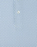 Close-up of a light blue and white micro-patterned fabric with a single white button at the center.