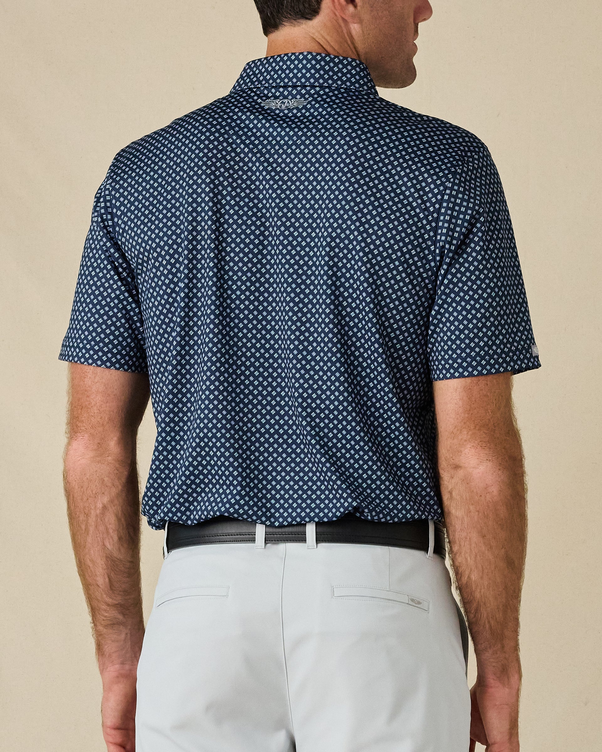 Back view of the Banksville Polo in New Indigo, showing the all-over geometric print and embroidered logo below the collar.