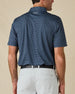 Back view of the Banksville Polo in New Indigo, showing the all-over geometric print and embroidered logo below the collar.