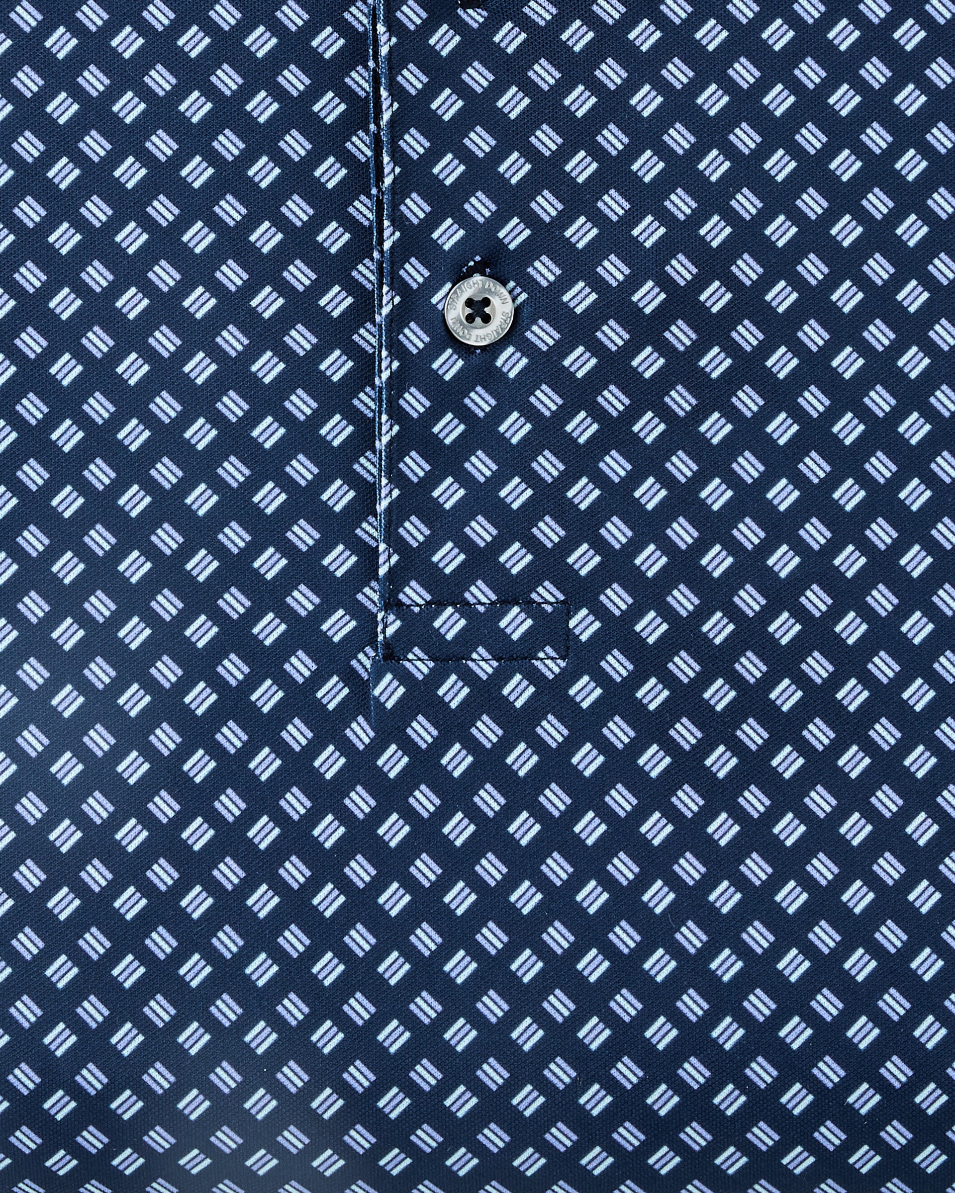 Close-up of the Banksville Polo in New Indigo, highlighting the repeating light blue geometric print and branded button detail.