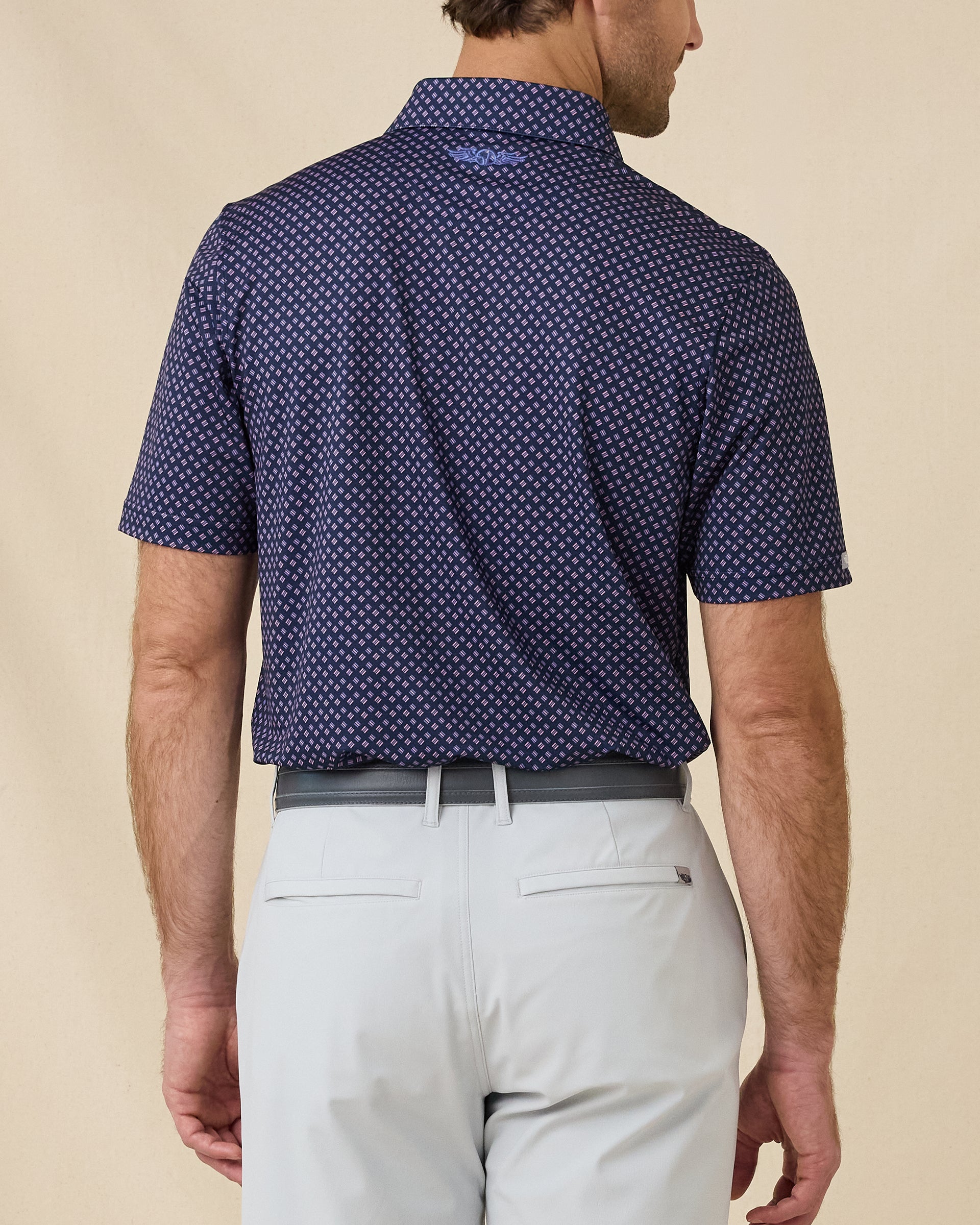 Rear view of the Banksville Polo in Tidal Blue featuring the allover geometric pattern and embroidered Straight Down logo below the collar