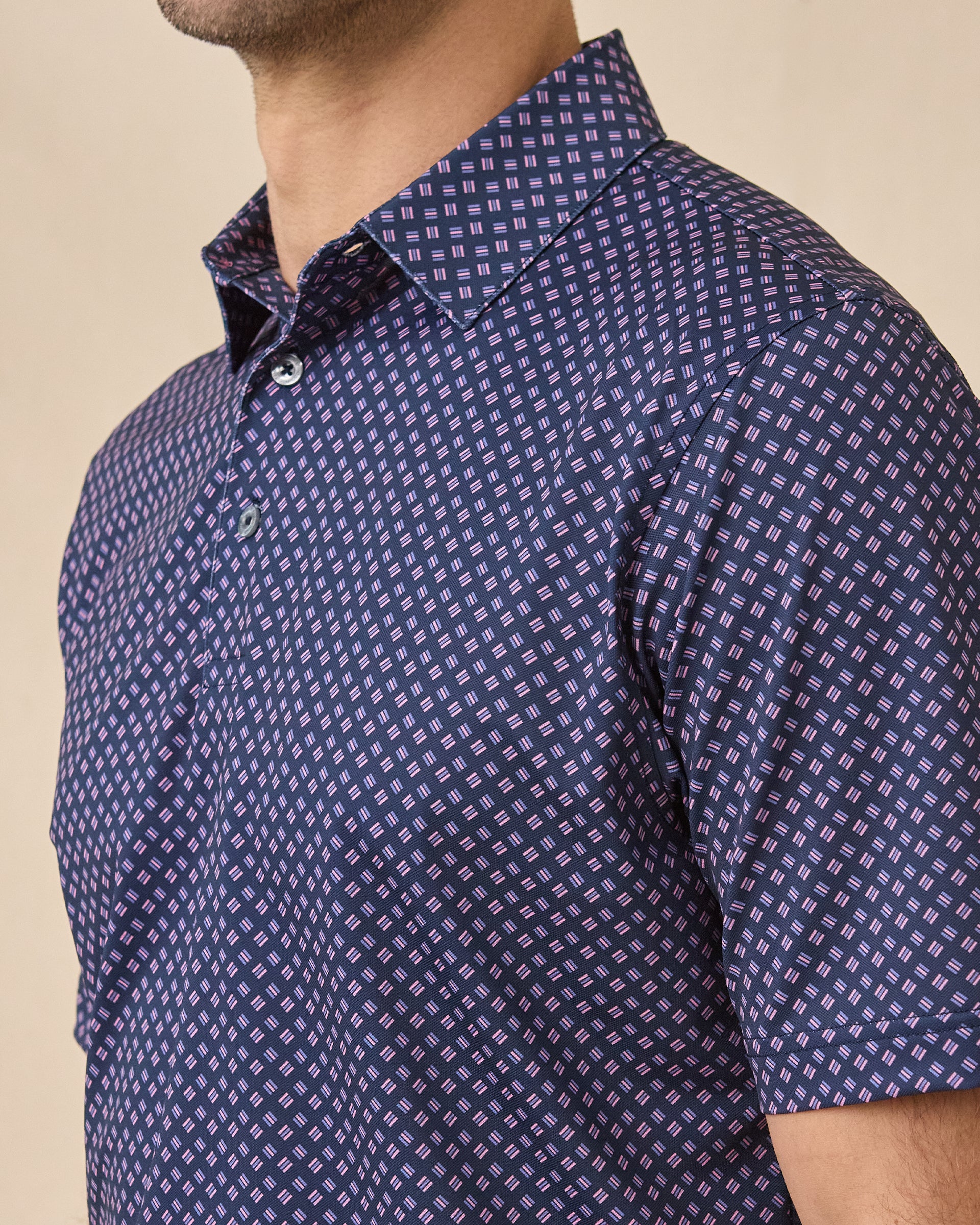 Close-up of the Banksville Polo in Tidal Blue showcasing the structured collar, button placket, and geometric print