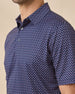 Close-up of the Banksville Polo in Tidal Blue showcasing the structured collar, button placket, and geometric print