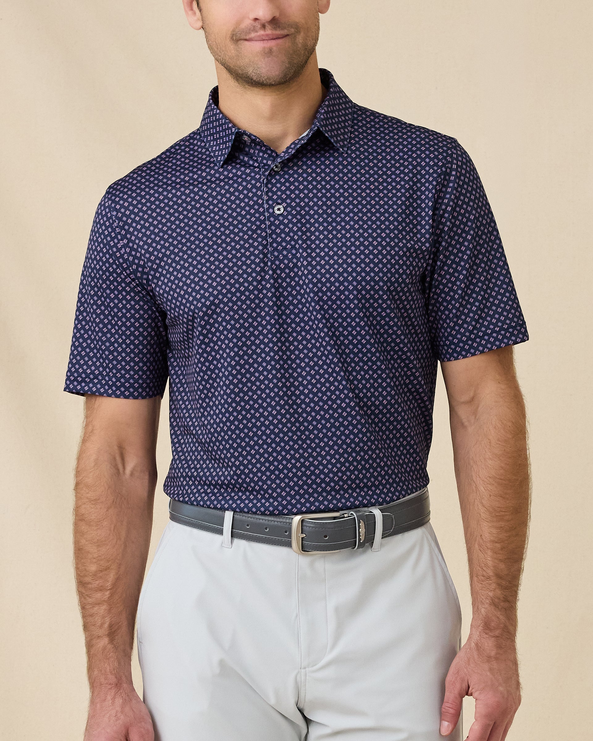 Model wearing the Banksville Polo in Tidal Blue with geometric print