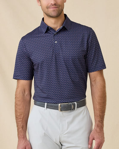 Model wearing the Banksville Polo in Tidal Blue with geometric print