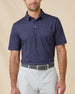 Model wearing the Banksville Polo in Tidal Blue with geometric print