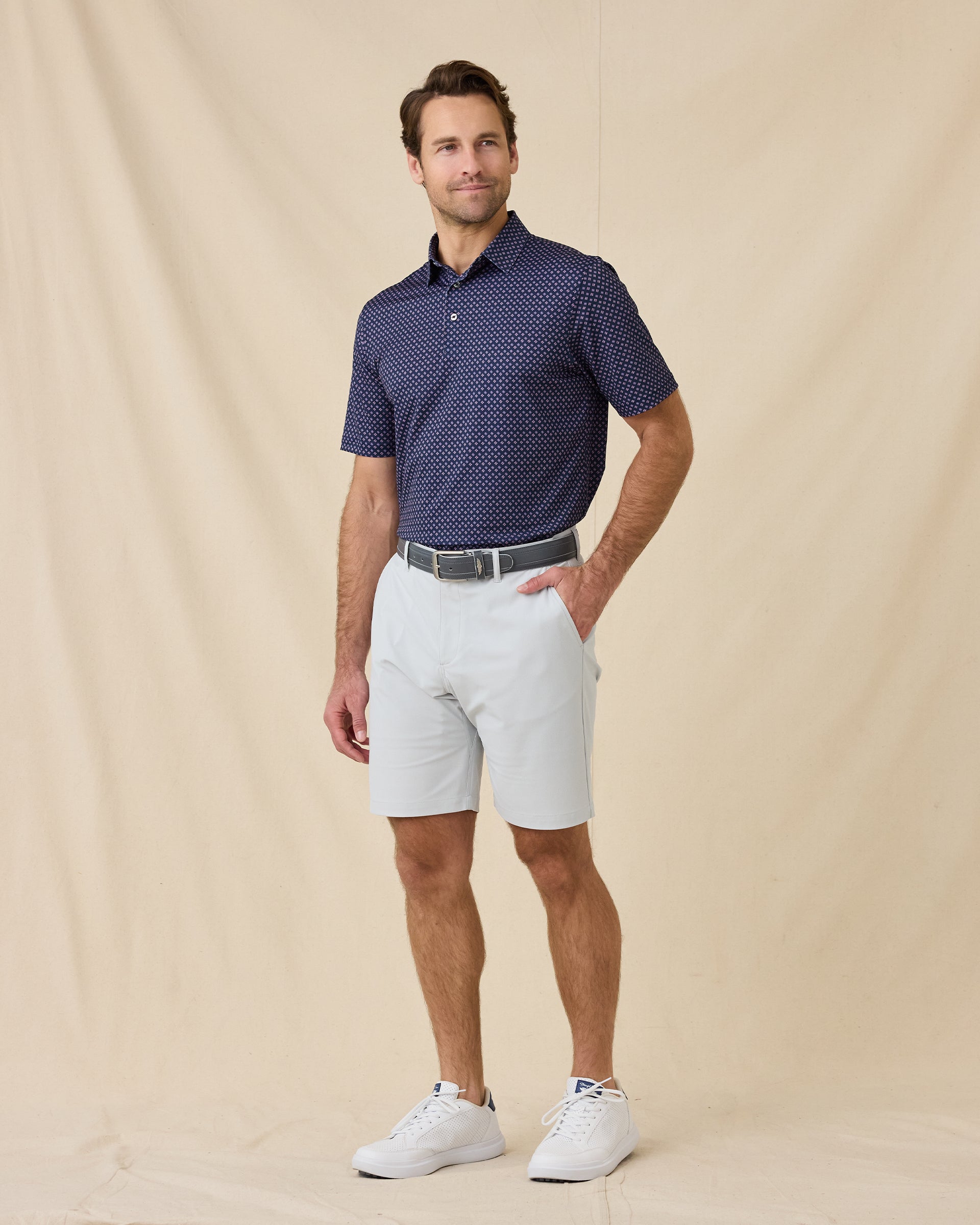 Model wearing the Banksville Polo in Tidal Blue styled with light gray golf shorts