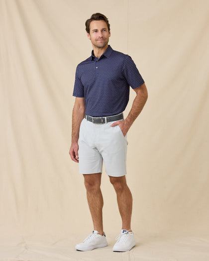 Model wearing the Banksville Polo in Tidal Blue styled with light gray golf shorts