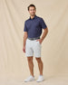 Model wearing the Banksville Polo in Tidal Blue styled with light gray golf shorts
