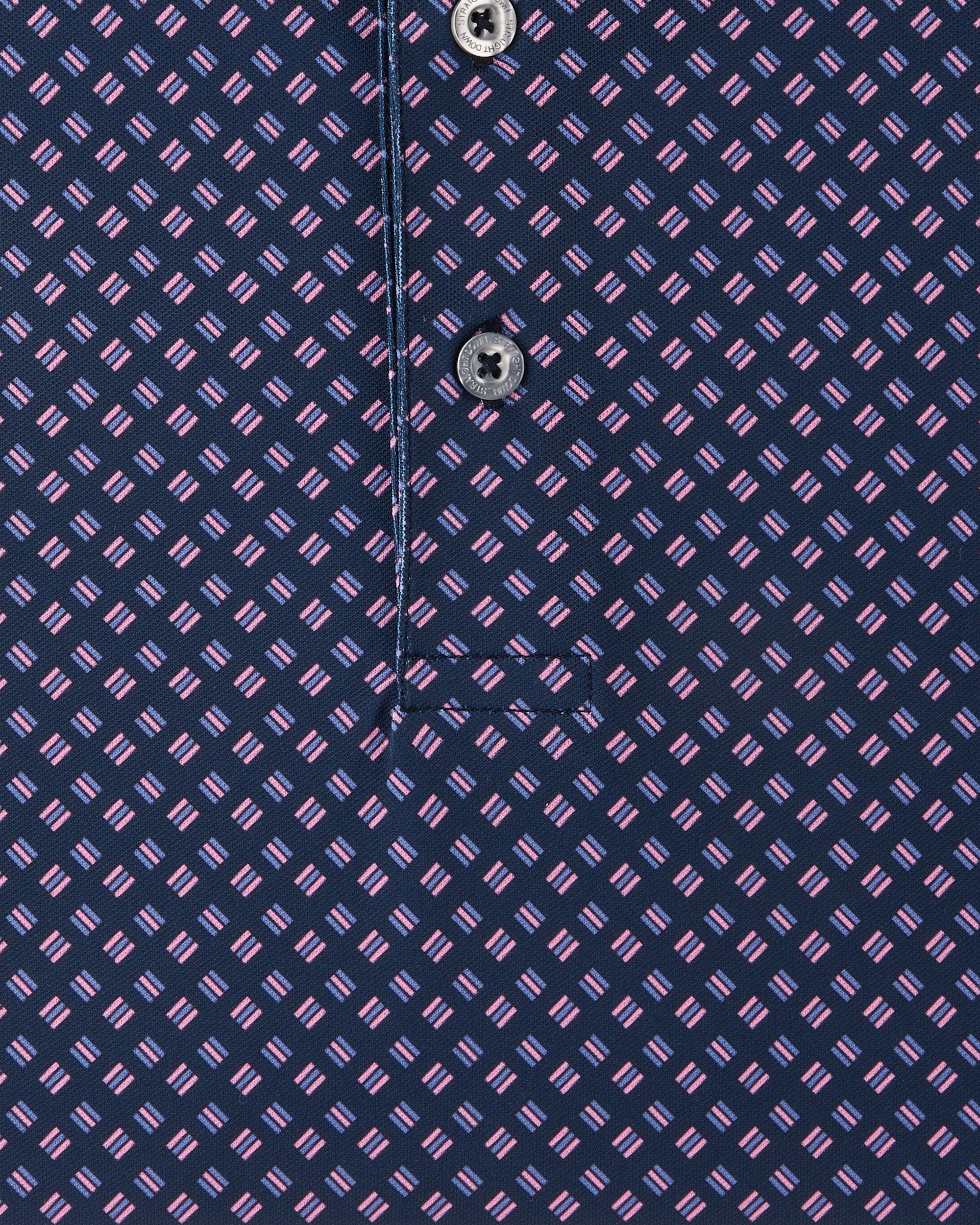 Close-up of the Banksville Polo in Tidal Blue highlighting the pink geometric pattern