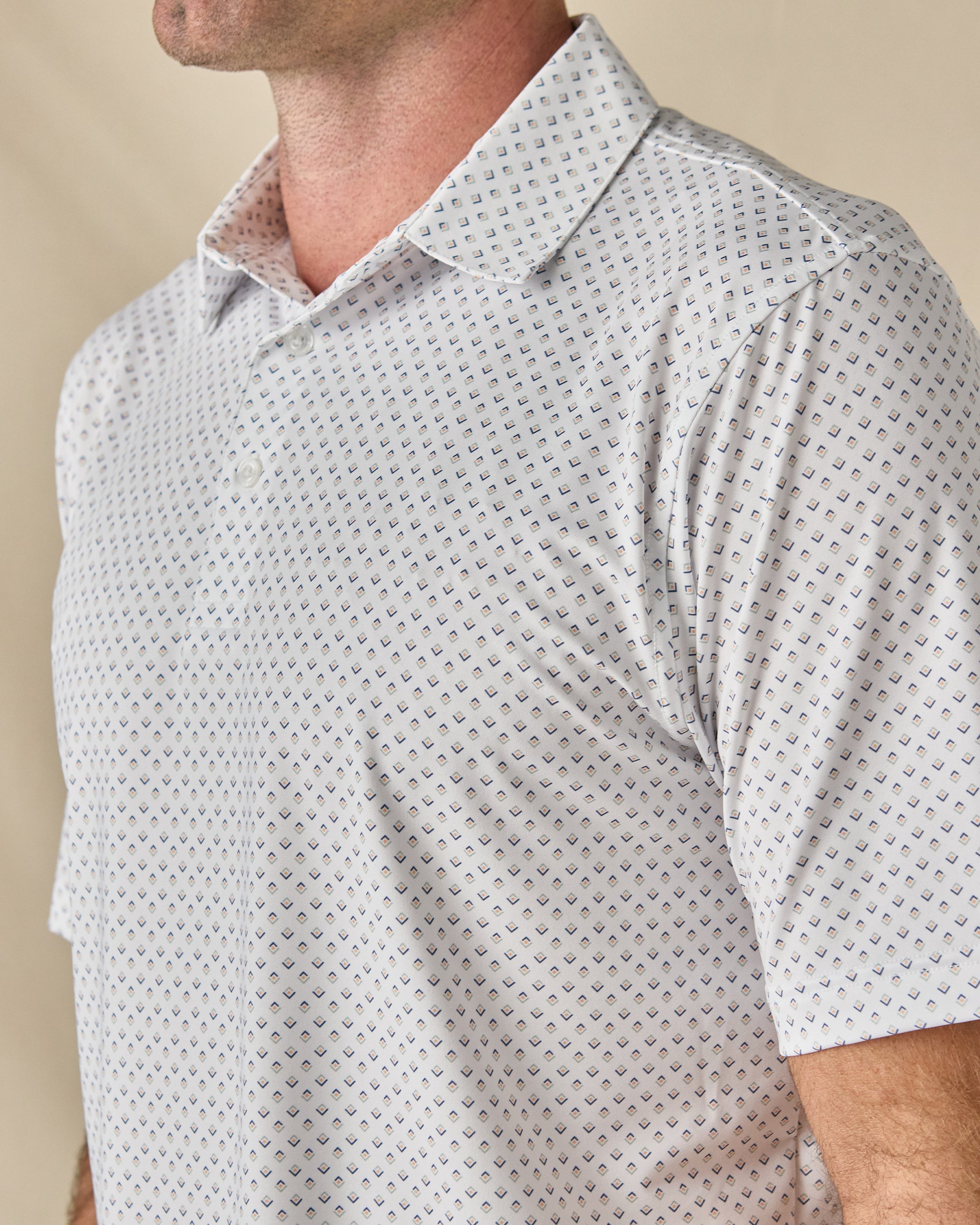 Close-up of the Brookhurst Polo in Herb, highlighting the refined geometric print and classic polo collar.