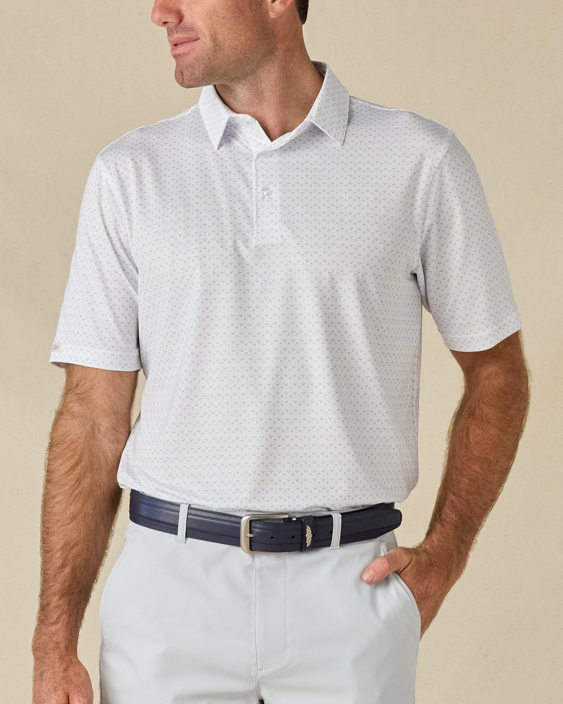Model wearing the Brookhurst Polo in Mint Tea, featuring a subtle all-over geometric print and classic three-button collar.