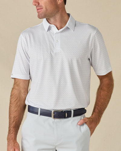 Model wearing the Brookhurst Polo in Mint Tea, featuring a subtle all-over geometric print and classic three-button collar.