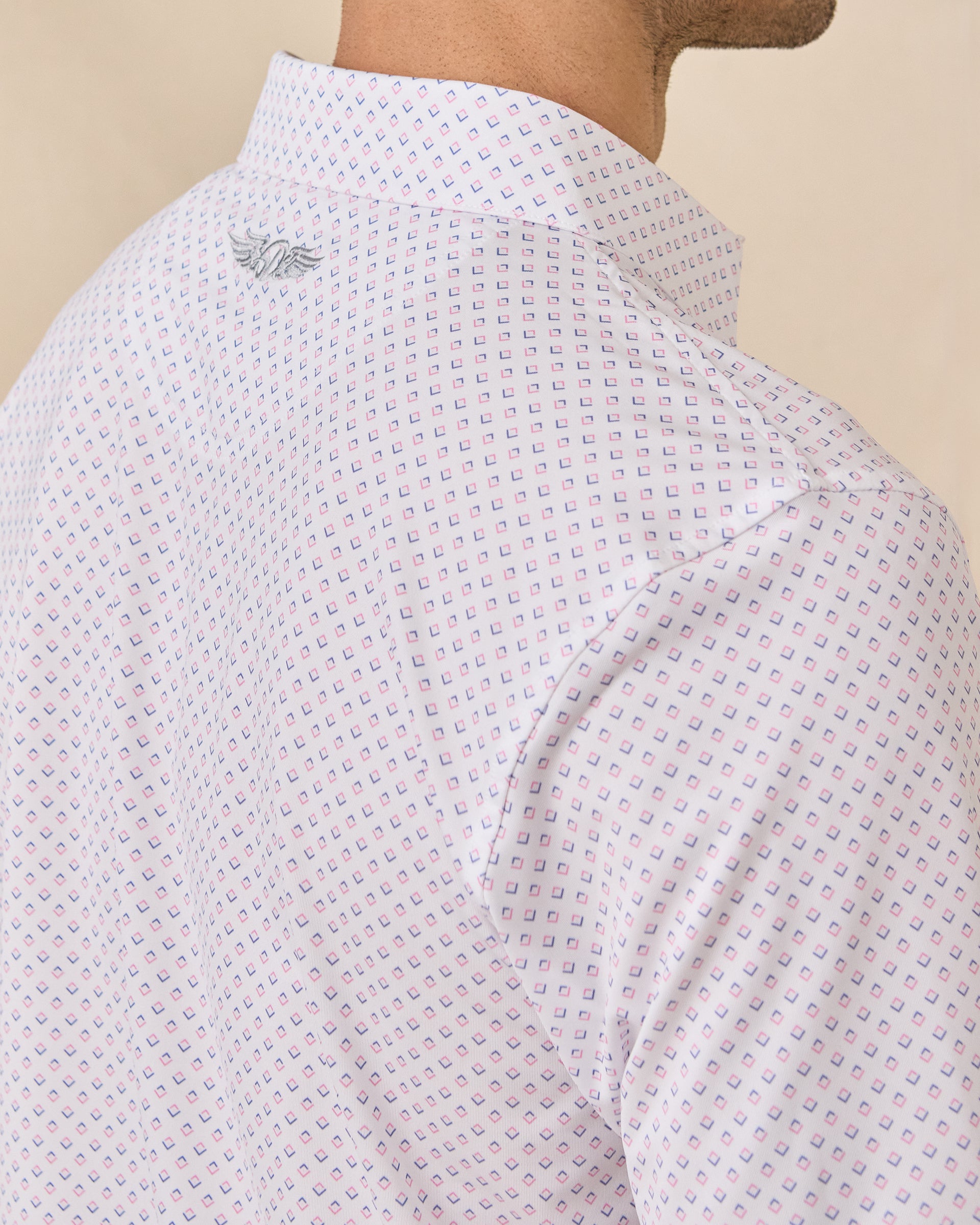 Back shoulder detail of the Brookhurst Polo in Punch Pink featuring the embroidered Straight Down logo