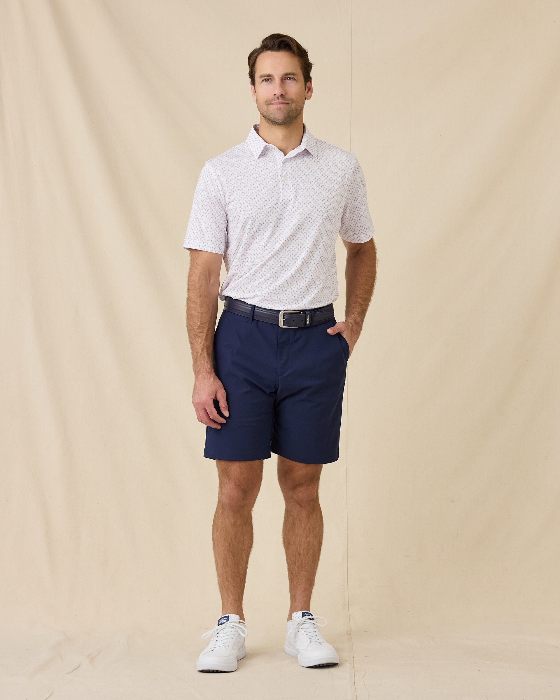 Model styled in the Brookhurst Polo in Punch Pink with navy shorts