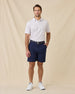 Model styled in the Brookhurst Polo in Punch Pink with navy shorts