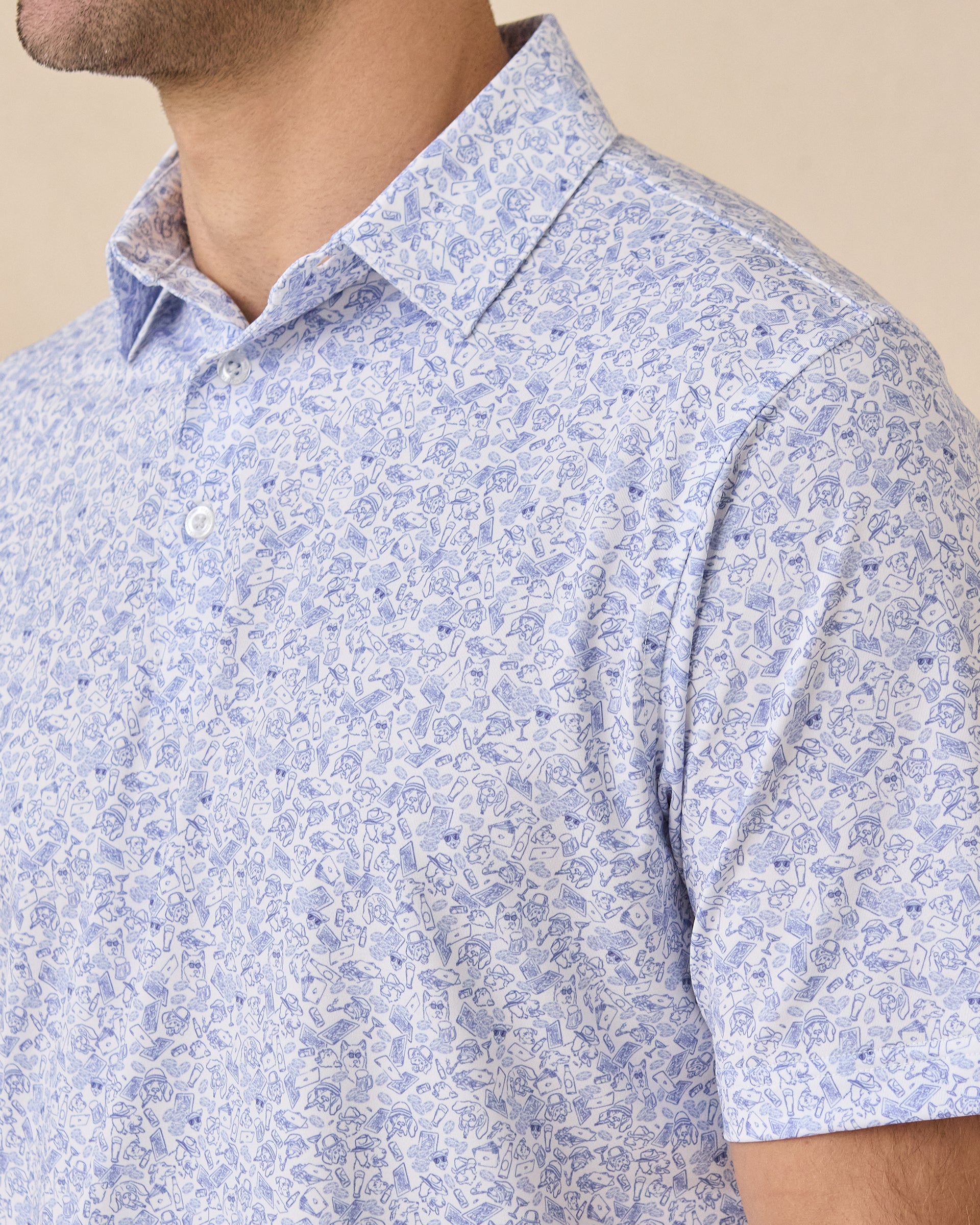 Collar detail of the Poker Dawgs Polo in Tidal Blue showcasing the allover poker-themed dog print