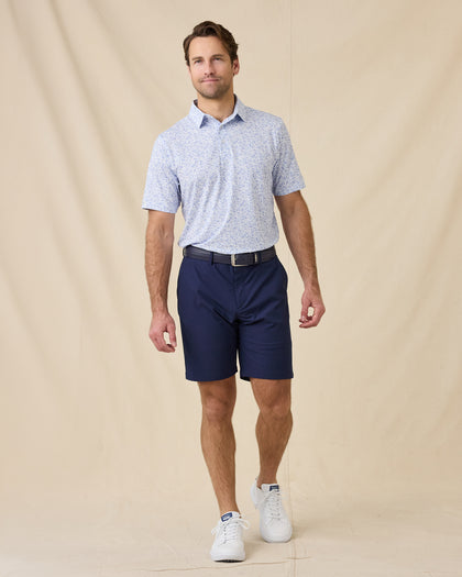 Model wearing the Poker Dawgs Polo in Tidal Blue paired with navy golf shorts