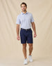 Model wearing the Poker Dawgs Polo in Tidal Blue paired with navy golf shorts