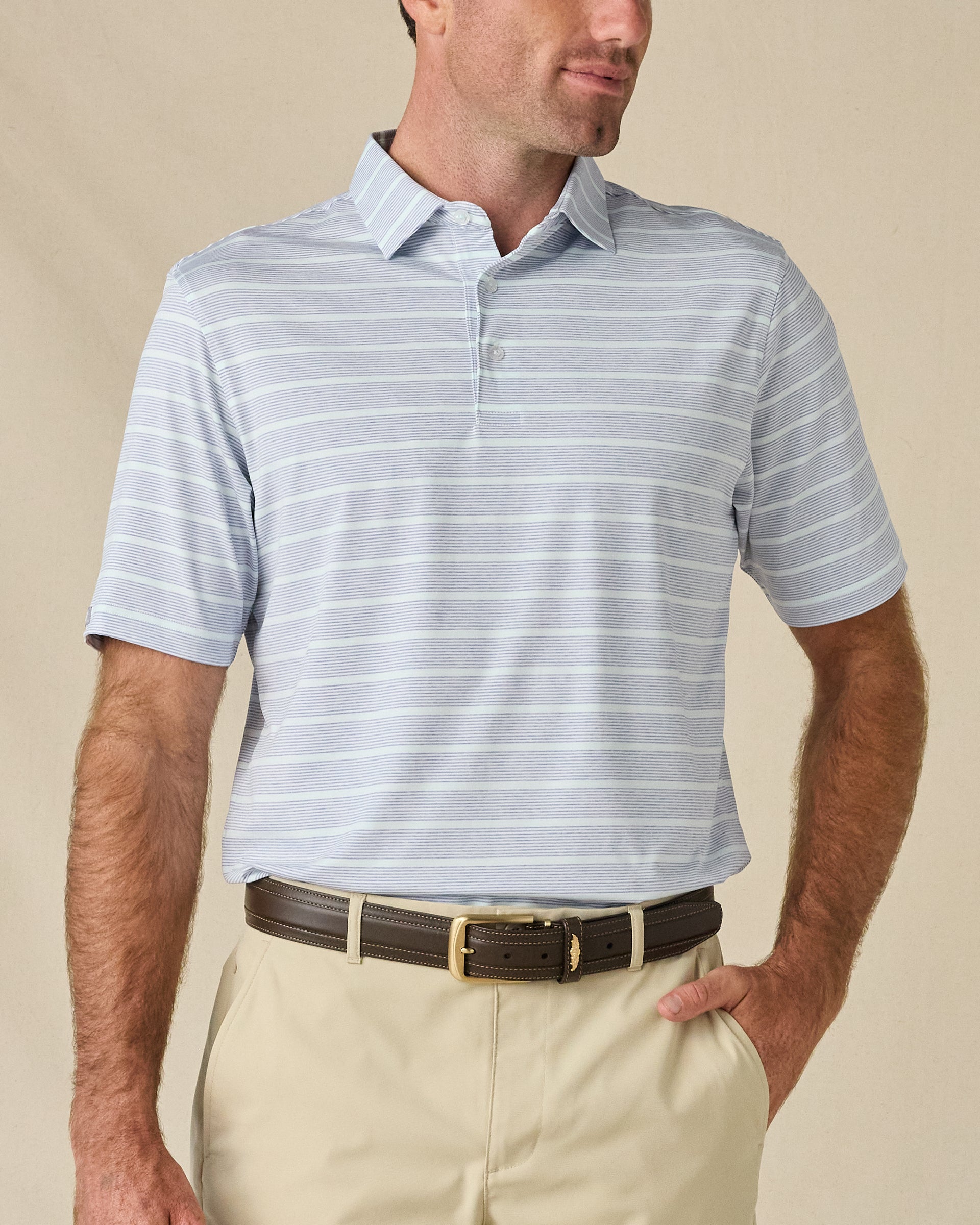 Model wearing the Oceano Dunes Striped Polo in Blue Shade, featuring fine blue horizontal stripes and a classic three-button collar.