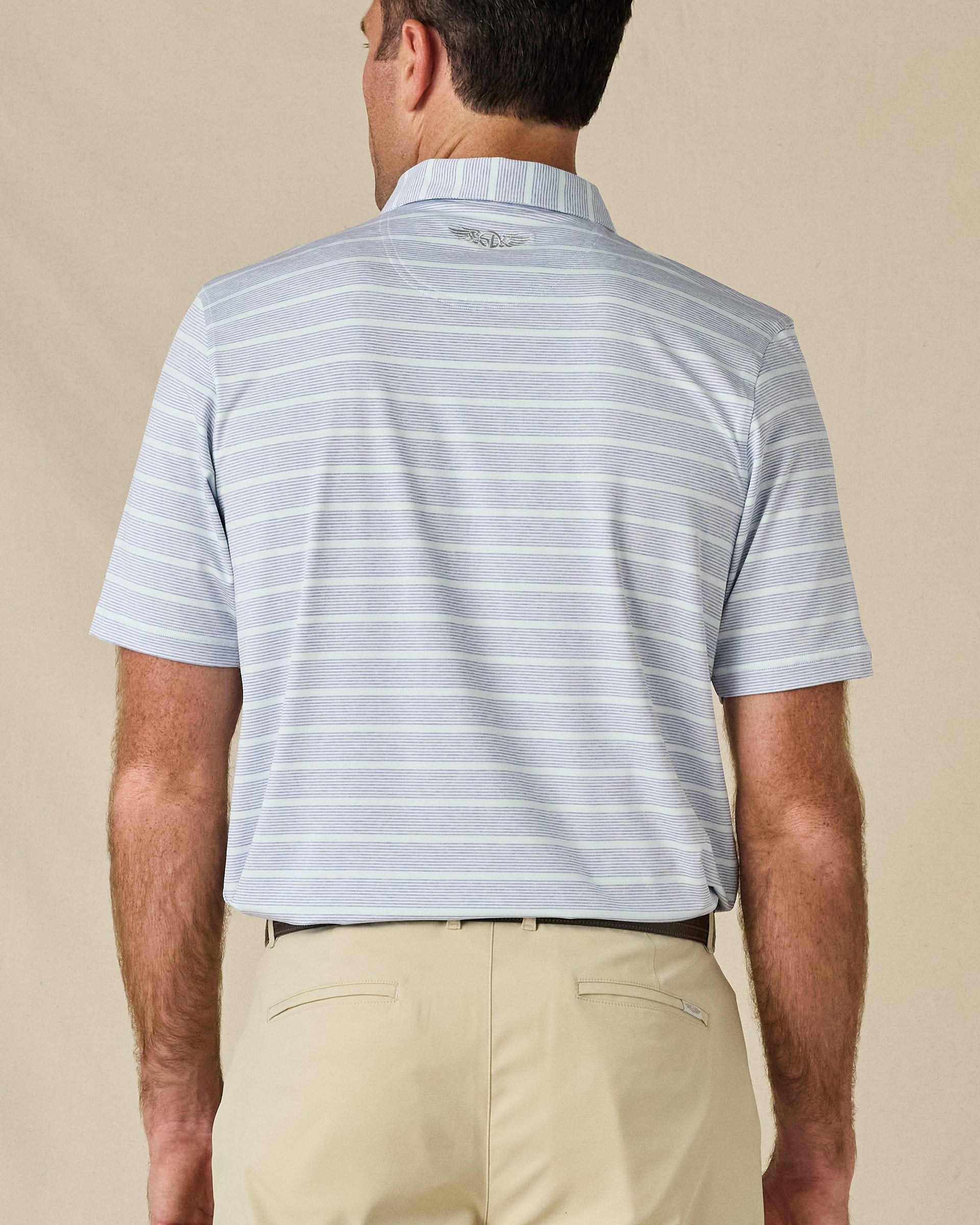 Back view of the Oceano Dunes Striped Polo in Blue Shade, highlighting the striped pattern and embroidered logo below the collar.