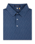 Close-up product view of the Casino Polo in Blue Shade, featuring an allover geometric pattern with small pastel playing card suit motifs, a classic collar, and button placket.