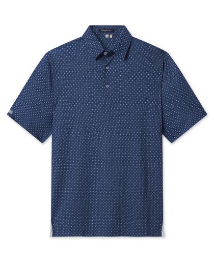 Front product view of the Casino Polo in Blue Shade, featuring a navy geometric print with subtle playing card suit motifs, short sleeves, and a button placket.