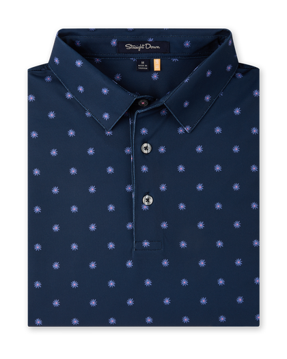 Close-up product view of the Al Fresco Polo in New Indigo, featuring an allover blue and pink floral motif, classic collar, and button placket.