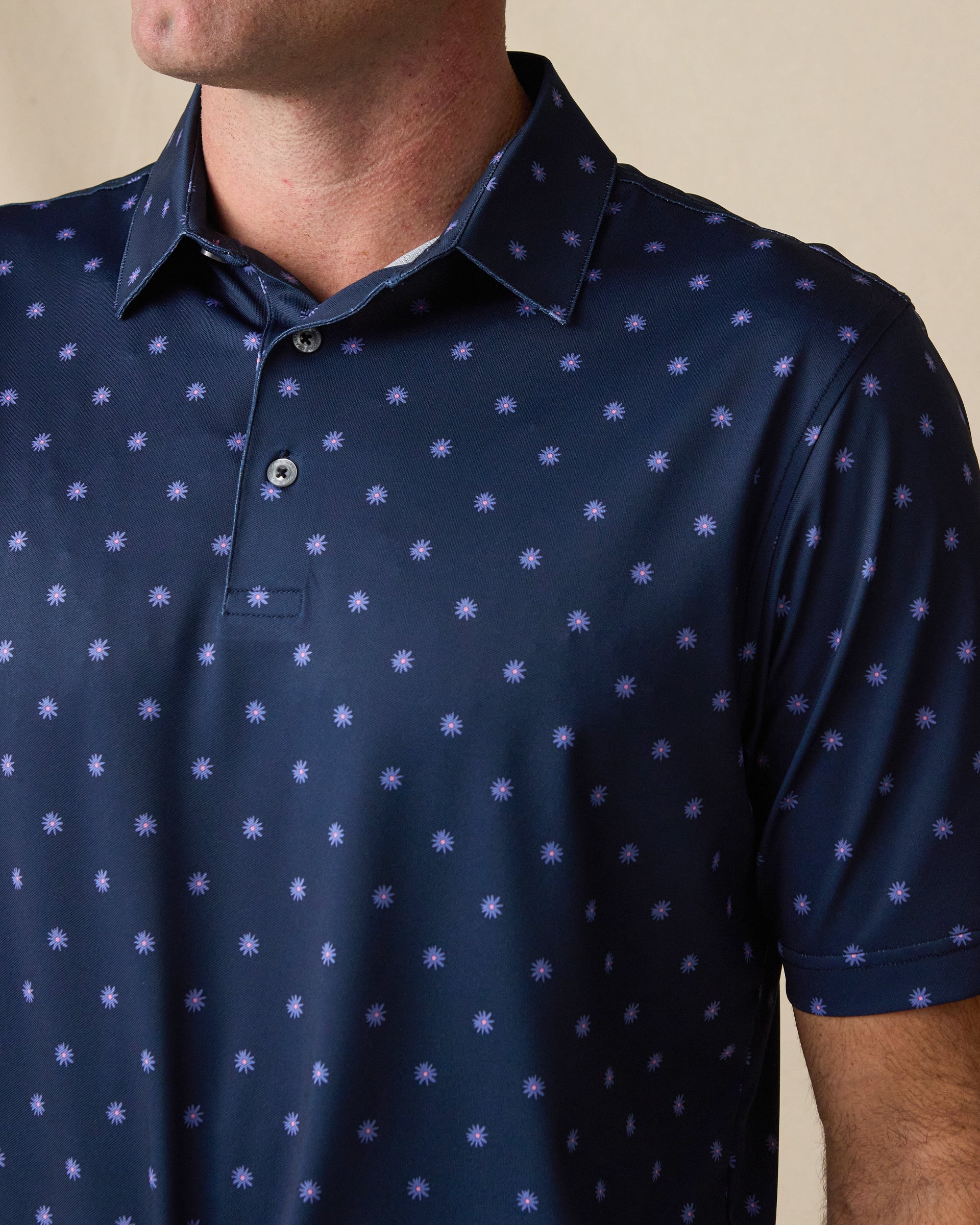 Close-up of the Al Fresco Polo in New Indigo, featuring a small floral-inspired print, classic collar, and button placket.