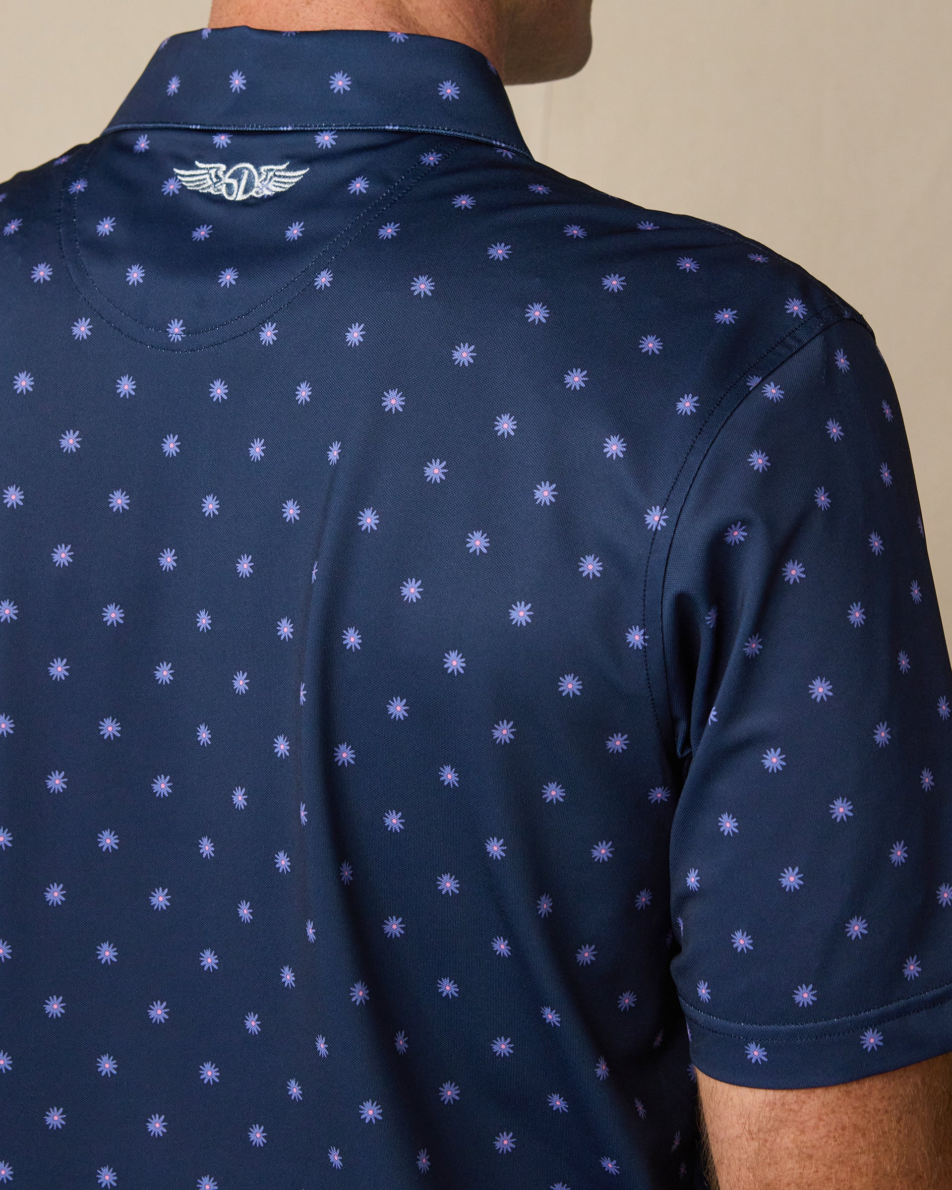 Close-up of the back of the Al Fresco Polo in New Indigo, highlighting the all-over print and embroidered Straight Down logo below the collar.