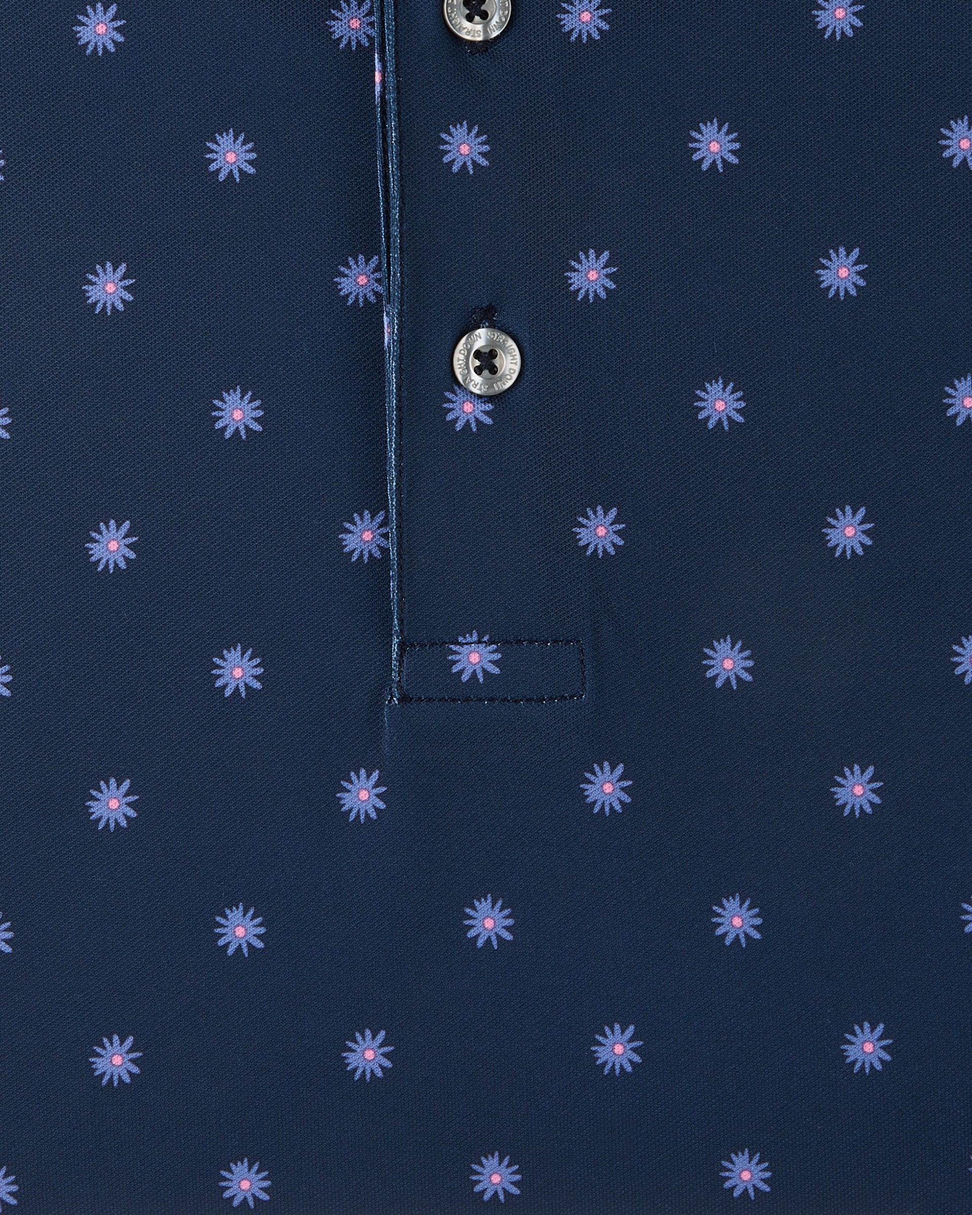 Detail view of the Al Fresco Polo in New Indigo showing the small blue floral motif with pink centers and branded buttons.