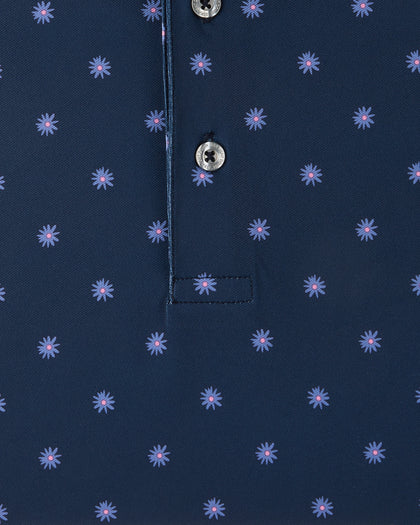 Detail view of the Al Fresco Polo in New Indigo showing the small blue floral motif with pink centers and branded buttons.