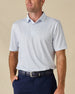 Model wearing the Hofbrau Polo in Blue Shade, featuring a subtle all-over novelty print and classic polo collar.
