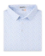Folded Hofbrau Polo in Blue Shade featuring an allover print of beer mugs, pretzels, alpine hats, and sausages in soft blue, teal, and purple tones.